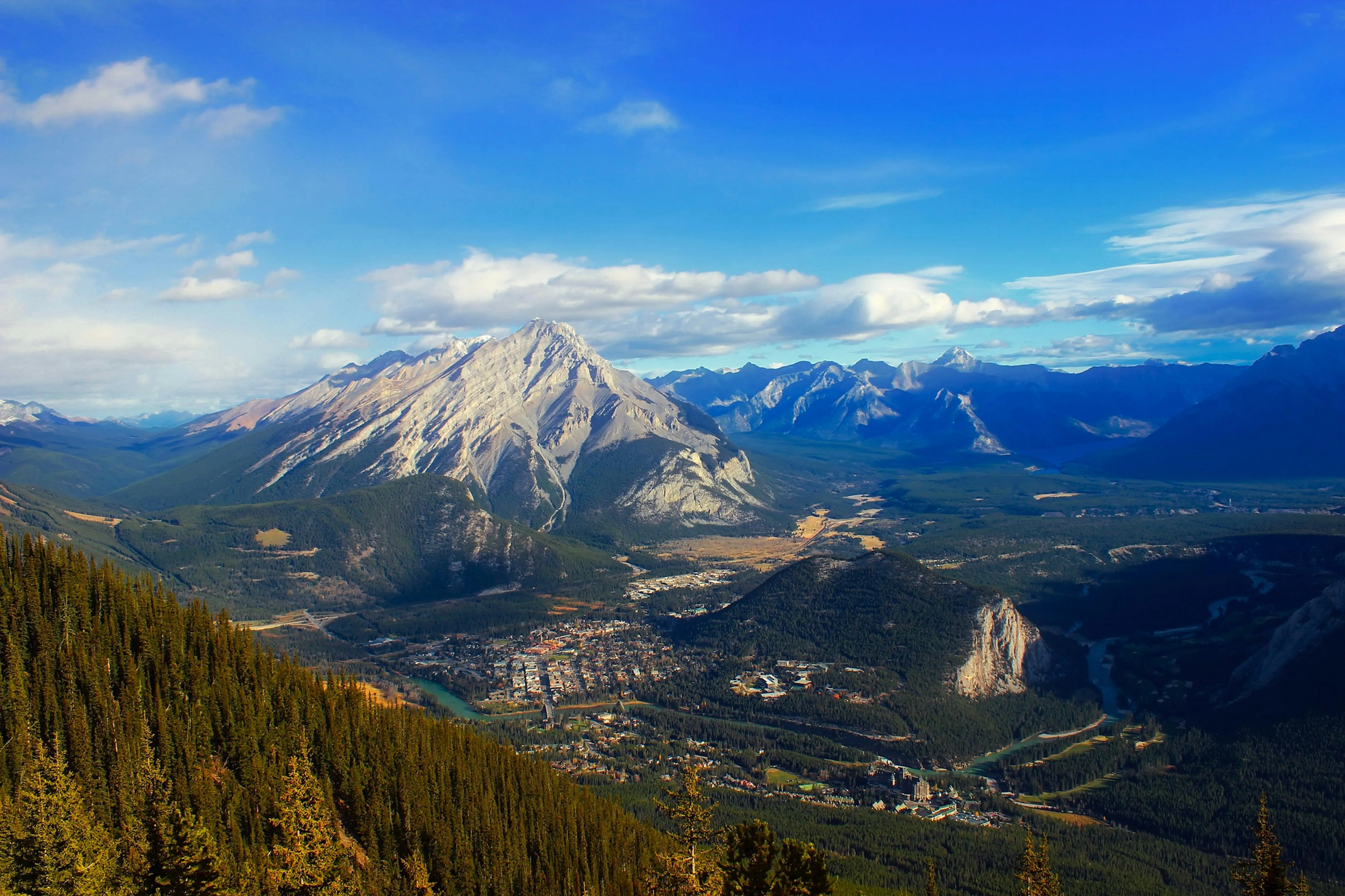 Aerial view of the majestic mountains and lush forests in Banff, Alberta, Canada.