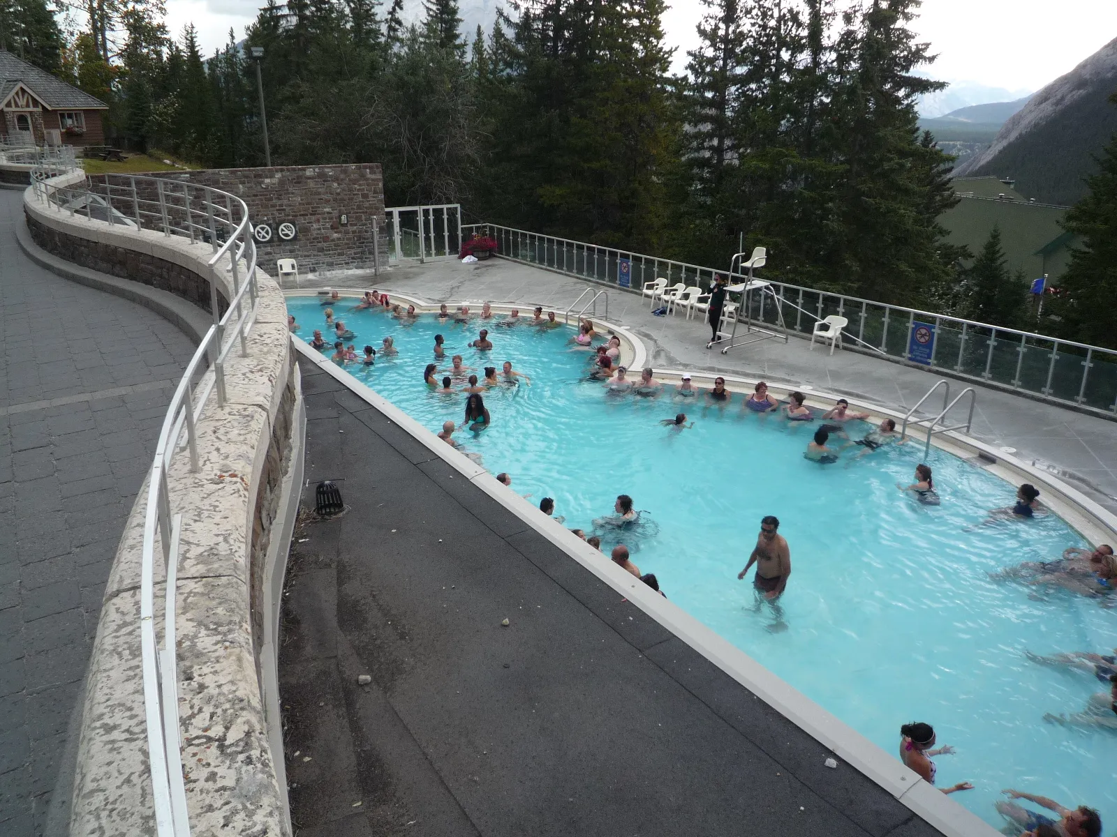Outdoor hot spring pool at Banff Upper Hot Springs surrounded by Rocky Mountain scenery in Banff National Park, Alberta.
